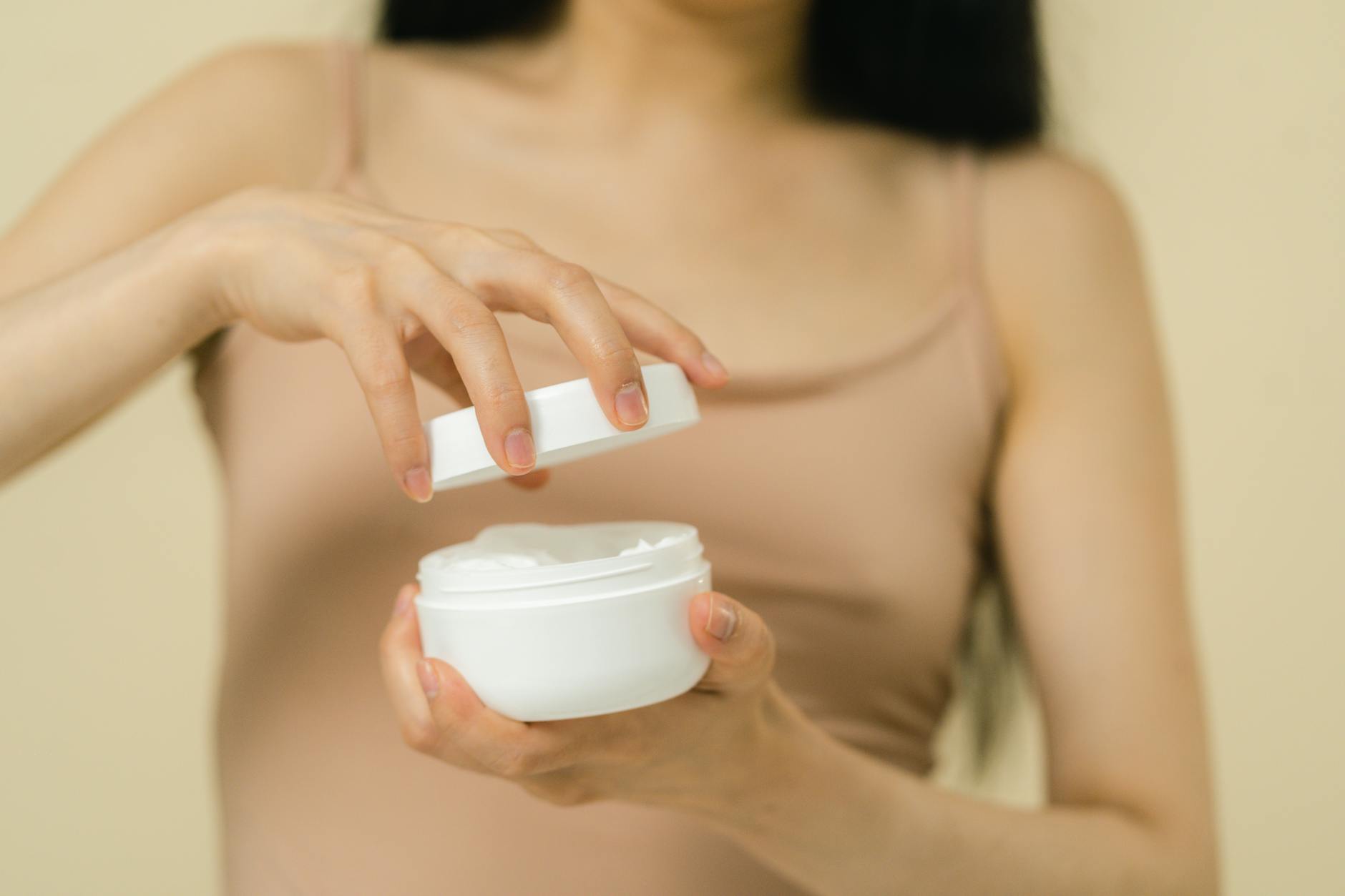 Woman opening cosmetic container